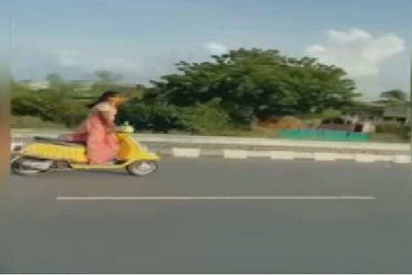 Woman worker adventures on scooter while Devineni Uma traveling 