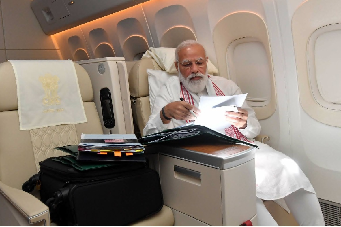 Modi busy on flight to US photo goes viral