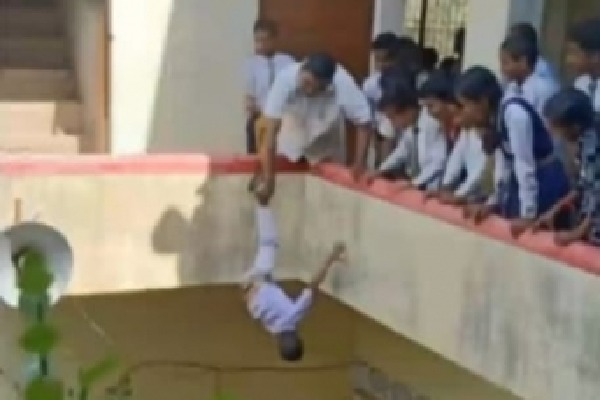 Principal hangs kid upside down from building