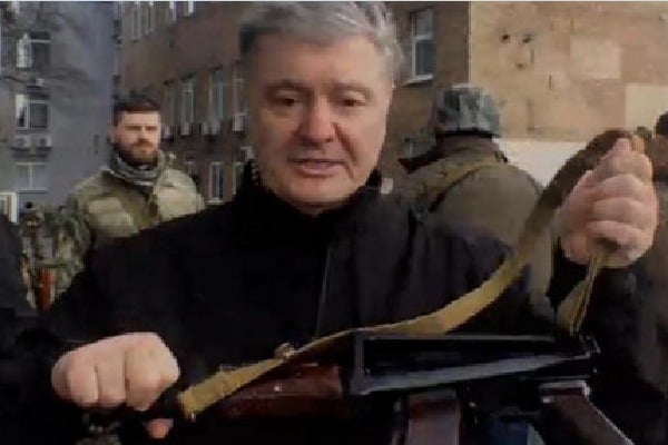Ukraine former president Petro Poroshenko holds gun to fight against Russian forces