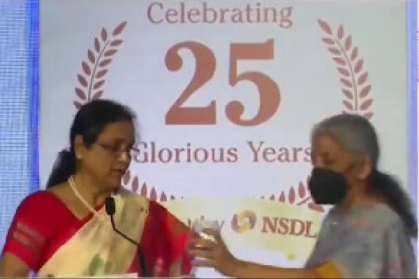 Nirmala Sitharaman gives drinking water to NSDL MD Padmaja Chunduru on stage