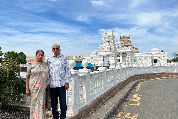 tdp mla gorantla posts a photo with his wife at new jersey venkateswara swamy temple