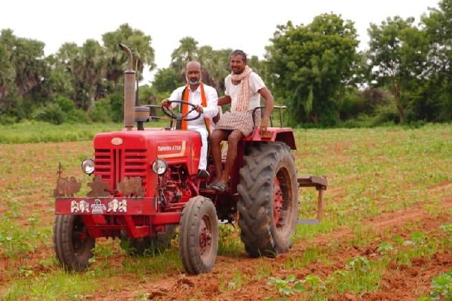 bandi sanjay rides a tractor in his padayatra