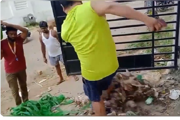 municipal employees threw severage before a house in vijayanagaram