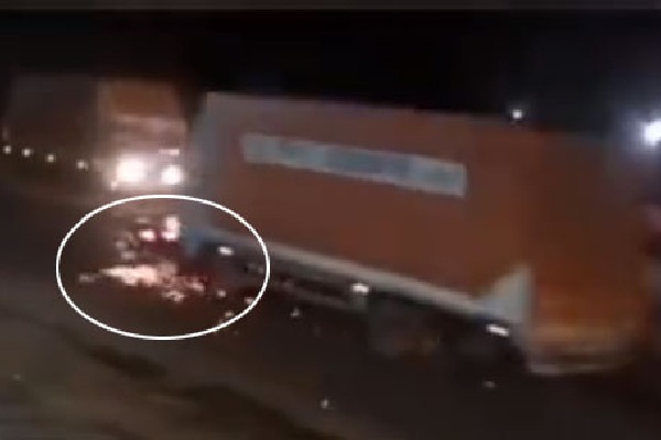 Shocking CCTV visual shows container truck dragging car following crash