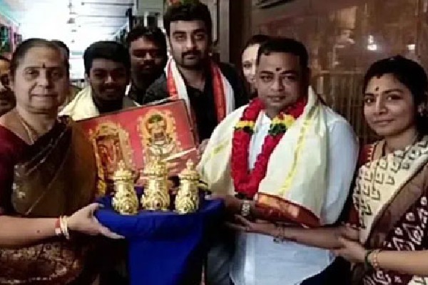 A devotee donates three golden crowns to goddess Kanaka Durga