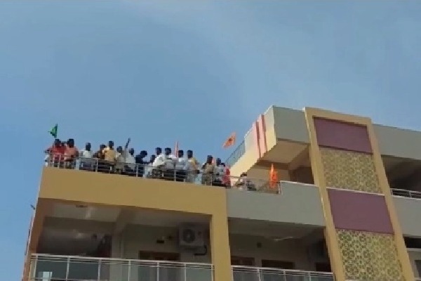 TDP leaders protest on a building near AP Assembly