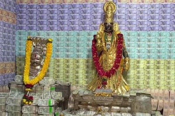 Gold and currency decorated deity in Penugonda