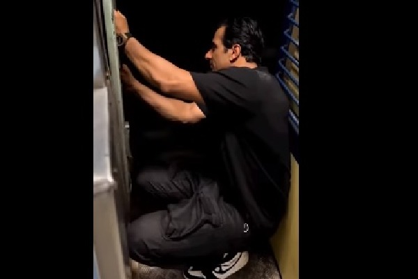 Sonu Sood sits by door of moving train