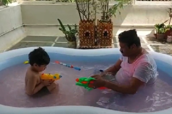 Talasani plays Holi with grandson in bath tub 