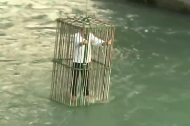 Italy town residents ridicule their politicians by putting them in a cage in a river