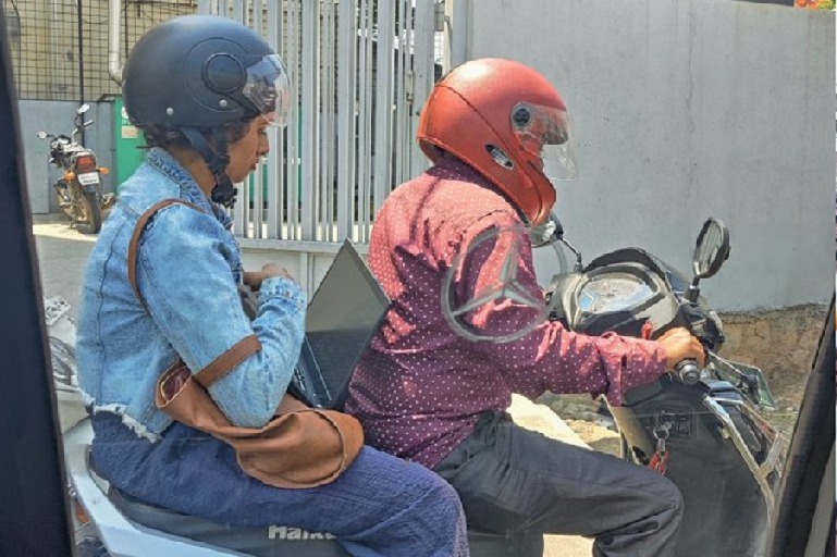 Pic of bengaluru woman working while struck in traffic goes viral 