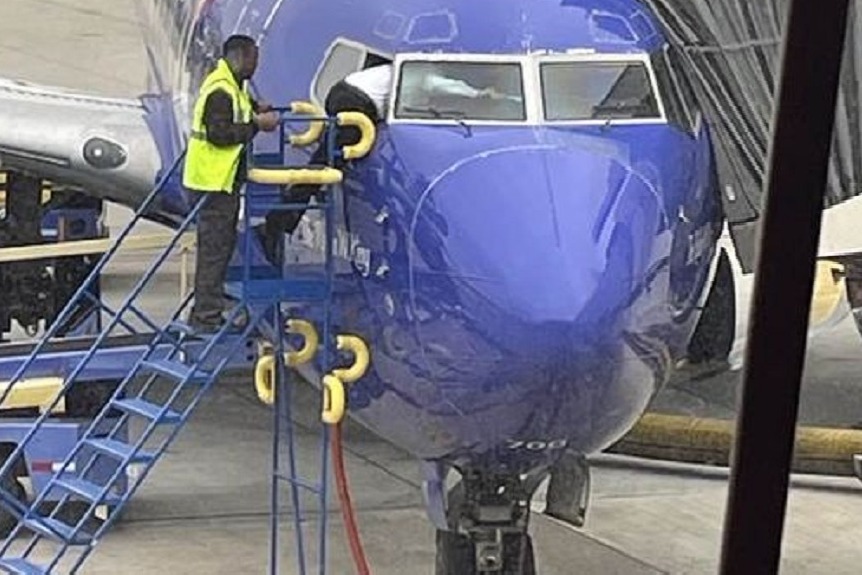 pilot crawls through cock pit window to open the doors accidentally locked by passengers 