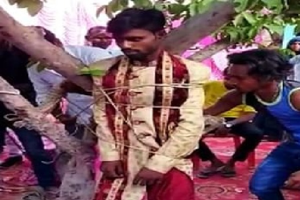 Groom tied to a tree by bride family for demanding dowry in UPs Pratapgarh