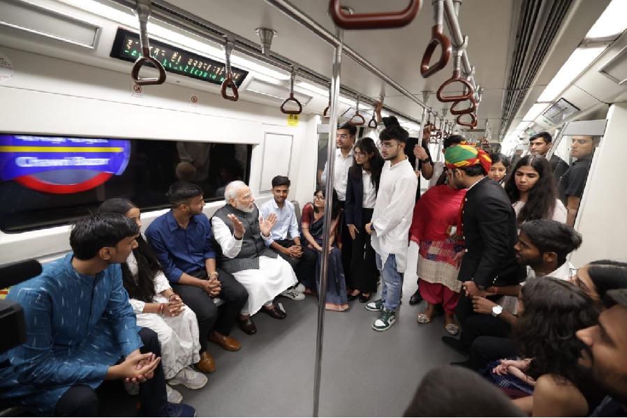 PM Modi takes metro on his way to DU, interacts with youngsters