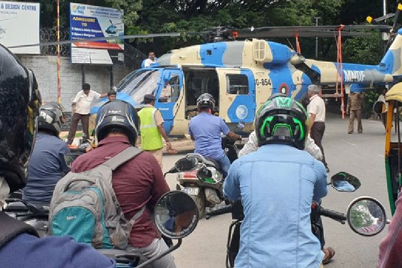 Helicopter lands in the middle of the road in bengaluru causing traffic jam