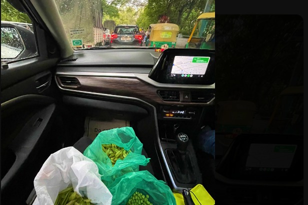 Woman peels green peas while waiting in Bengaluru traffic jam