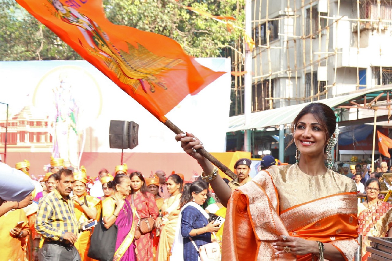 Shilpa waves saffron flag with Lord Ram's image at Siddhivinayak temple