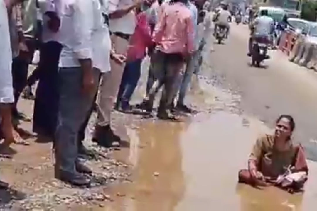 Woman sits in pothole to flag poor condition of roads in Hyderabad