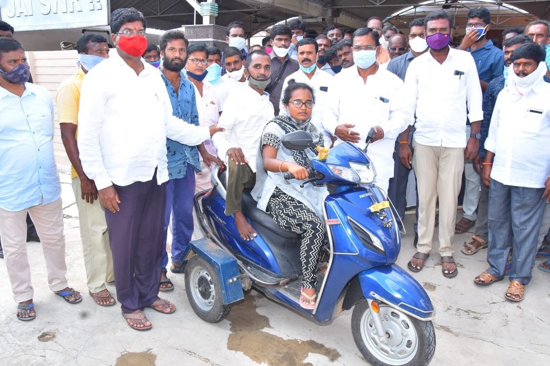 Telangana Minister Niranjan Reddy helps a handicapped person 