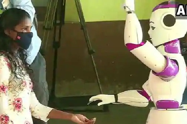 Robot helps voters to maintain Covid 19 in Kerala polling booth