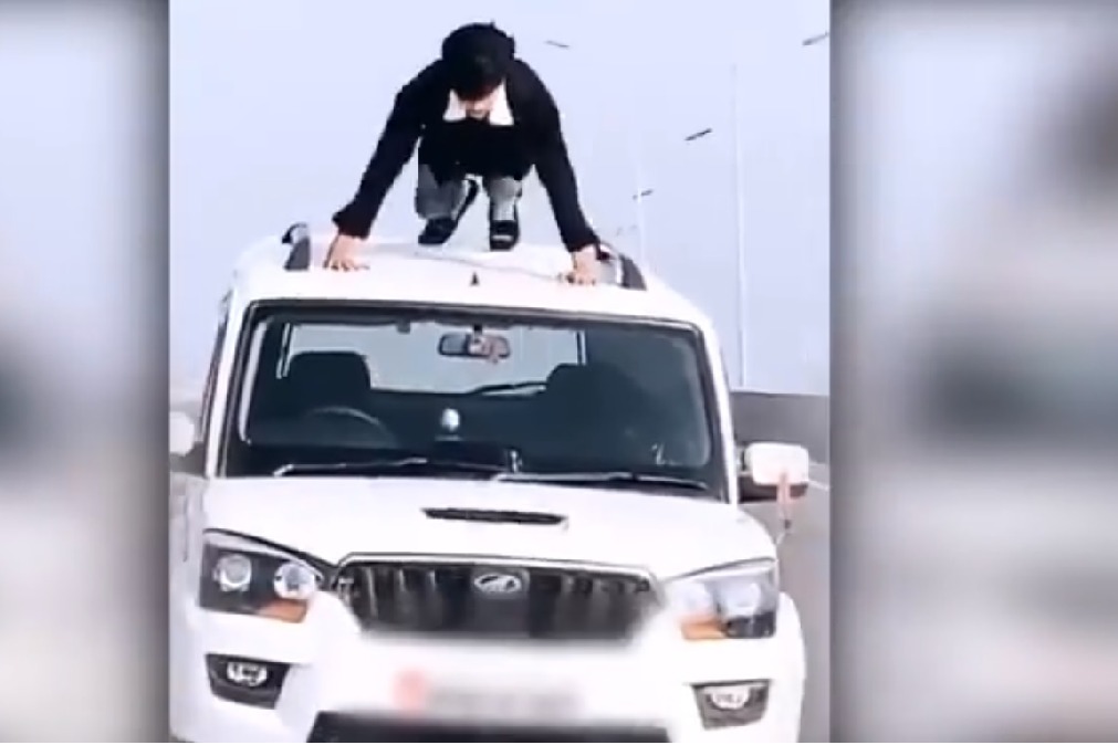 Man does push ups on roof of moving car in viral video