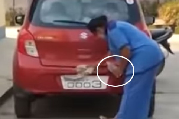 Government Doctor cleaning his car with Saline Bottle