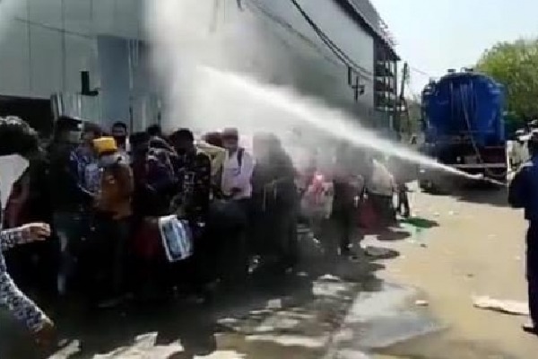Migrant workers sprayed with disinfectant in  Delhi 