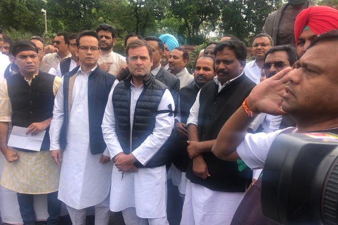 Rahul Gandhi and other Congress MPs protest near Mahatma Gandhi statue at Parliament
