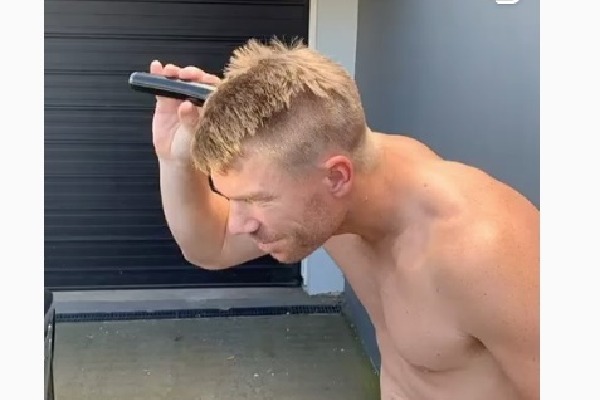 Warner shaves off head to show support towards medical staff 
