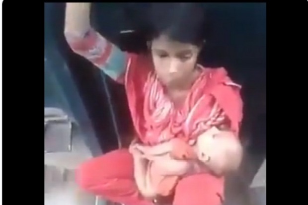 Woman with child sitting on train compartment link as police officer felt emotional