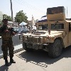 Taliban fighters force men into car boots
