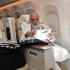 Modi busy on flight to US photo goes viral