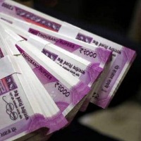 People rush to collect toy currency notes on Madapur raod