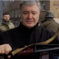 Ukraine former president Petro Poroshenko holds gun to fight against Russian forces