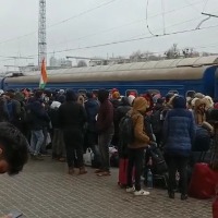 Students queue up at Kharkiv railway station as doors of trains remain shut