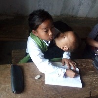 Manipur: 10-yr-old girl attends classes with sister in lap