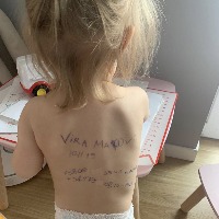 Ukraine Mothers writing family details on their children back