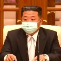 Kim Jong un wears mask for 1st time after North Korea confirms Covid outbreak