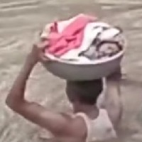 Baahubali scene: Man wades through neck-deep water to rescue infant at Manthani