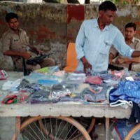 Street Vendor gets Two Gunmen Security