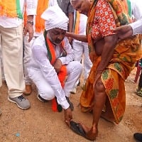 bjp posts a photo of bandi sanjay arranges slippers to a older lady