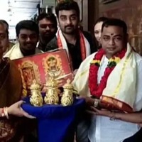 A devotee donates three golden crowns to goddess Kanaka Durga