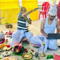 Youth works on laptop while his marriage being done