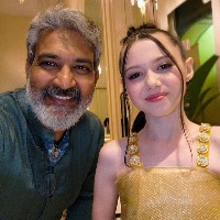 Rajamouli takes award from child actress Violet Mcgraw for RRR