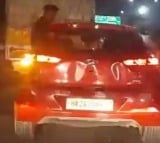 Noida: Youth sits on window of speeding car, probe underway