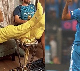 Pacer Mohammad Shami reacts to Mitchell Marsh putting his feet on the World Cup trophy