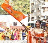Shilpa waves saffron flag with Lord Ram's image at Siddhivinayak temple