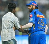 Fan who Enter into the Wankhede Stadium Ground and reach to Rohit Sharma during MI vs RR IPL 2024 Match