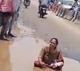 Woman sits in pothole to flag poor condition of roads in Hyderabad